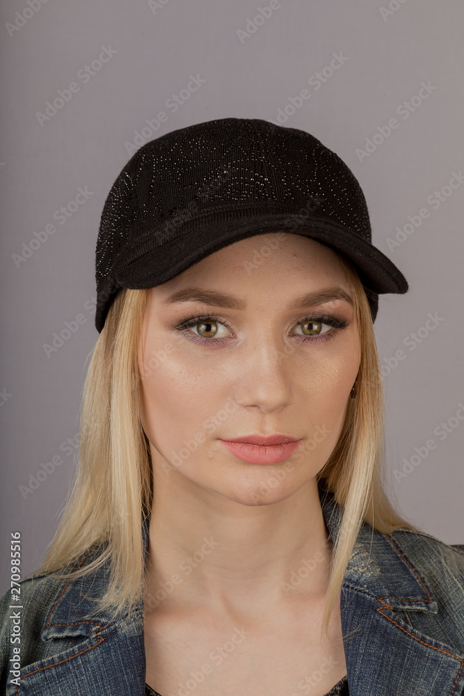 Beautiful girl with natural make-up in a headdress on a gray background. Beautiful girl with natural make-up in a headdress on a gray background.