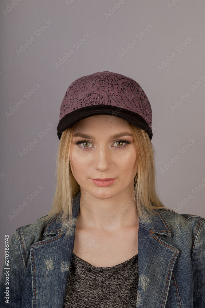 Beautiful girl with natural make-up in a headdress on a gray background. Beautiful girl with natural make-up in a headdress on a gray background.