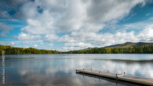 Pristine lake in the Adirondacks with dock on a sunny day