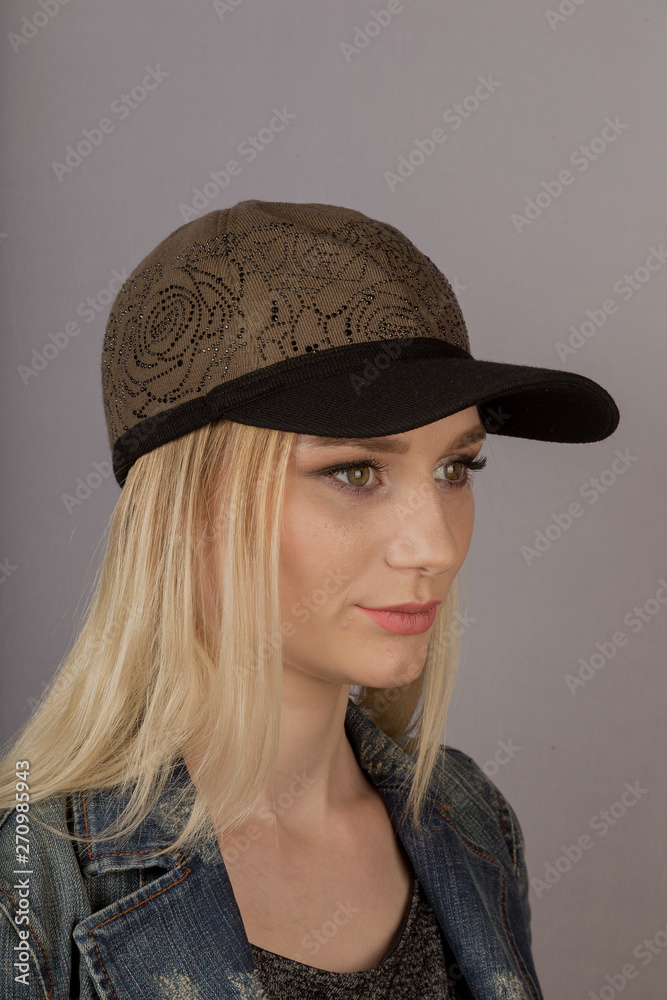 Beautiful girl with natural make-up in a headdress on a gray background. Beautiful girl with natural make-up in a headdress on a gray background.
