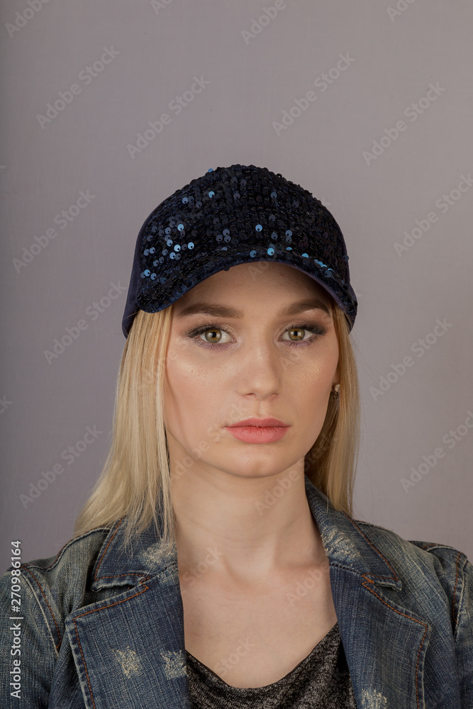 Beautiful girl with natural make-up in a headdress on a gray background. Beautiful girl with natural make-up in a headdress on a gray background.
