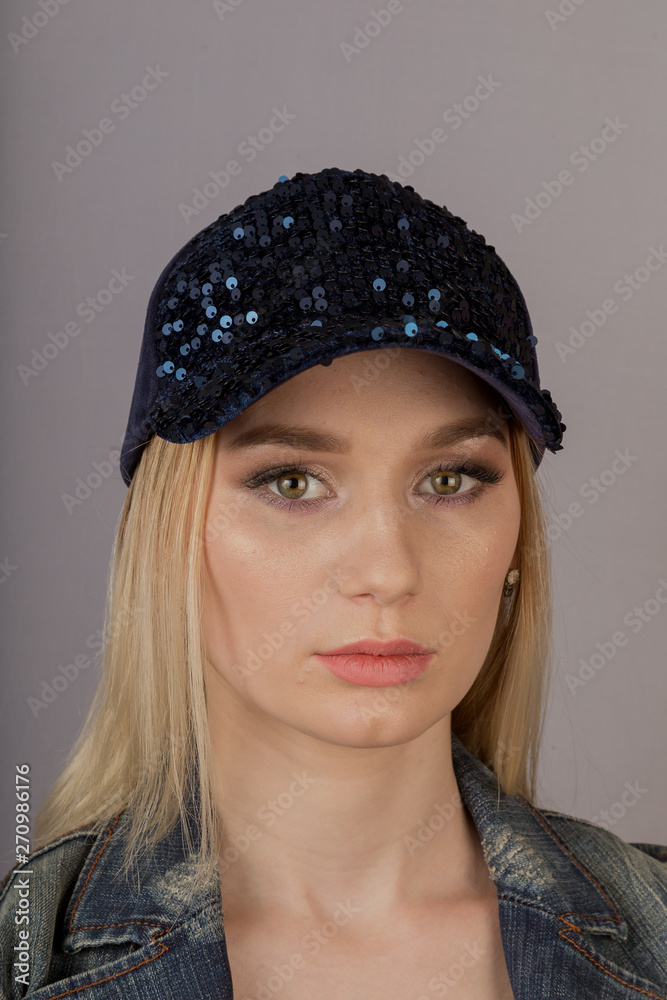 Beautiful girl with natural make-up in a headdress on a gray background. Beautiful girl with natural make-up in a headdress on a gray background.
