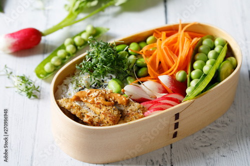 Japanese style bento lunch box with chicken, rice and vegetables