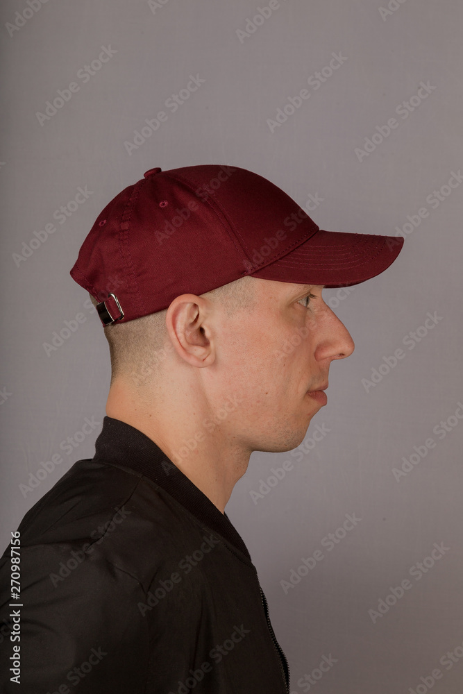 Handsome young man in a headdress on a gray background. Handsome young man in a headdress on a gray background.
