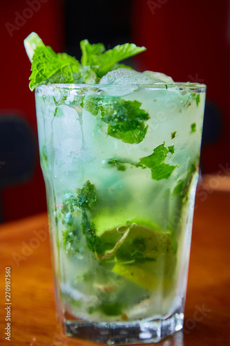 Summer fresh classic mojito with mint and lime garnish on bar top in restaurant 