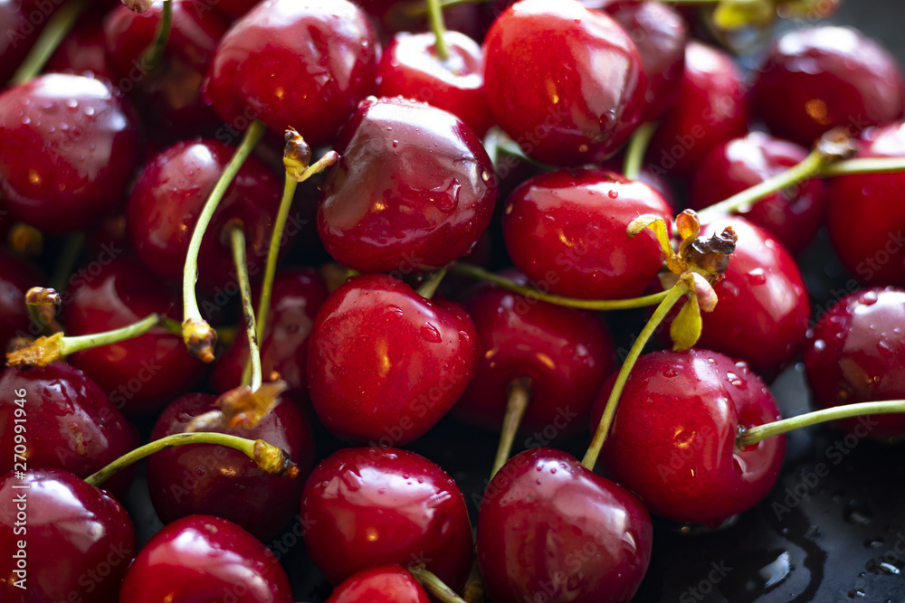 Closeup of ripe cherries with stalks and leaves