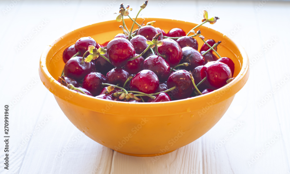 Cherries in color bowl on a table, ripe berry Cherries in color bowl on a table, ripe berry