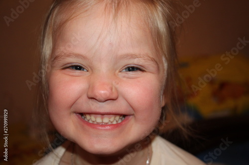 little girl laughs and makes faces, portrait