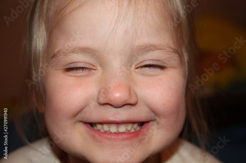 little girl laughs and makes faces  portrait