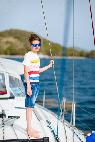 Teenage boy on board of sailing yacht