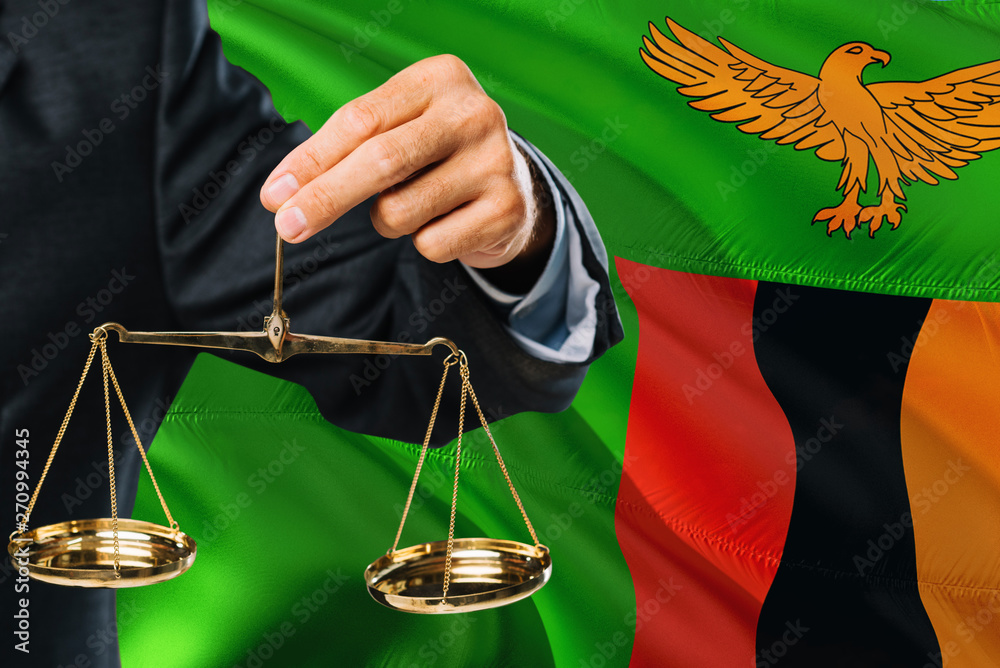 Zambian Judge is holding golden scales of justice with Zambia waving