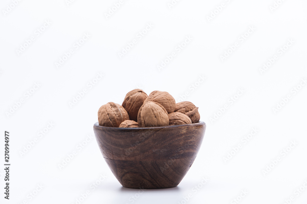 walnuts in a bowl isolated on white walnuts in a bowl isolated on white