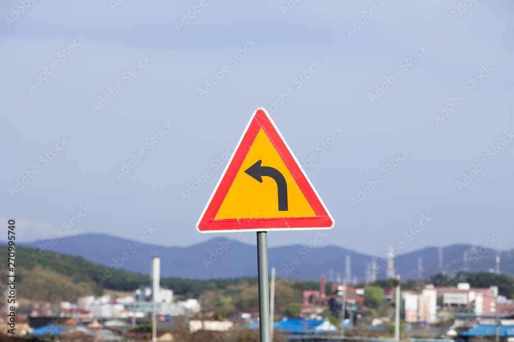 Triangle road sign left turn in south korea countryside