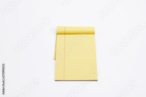Yellow pencil on lined note paper isolated