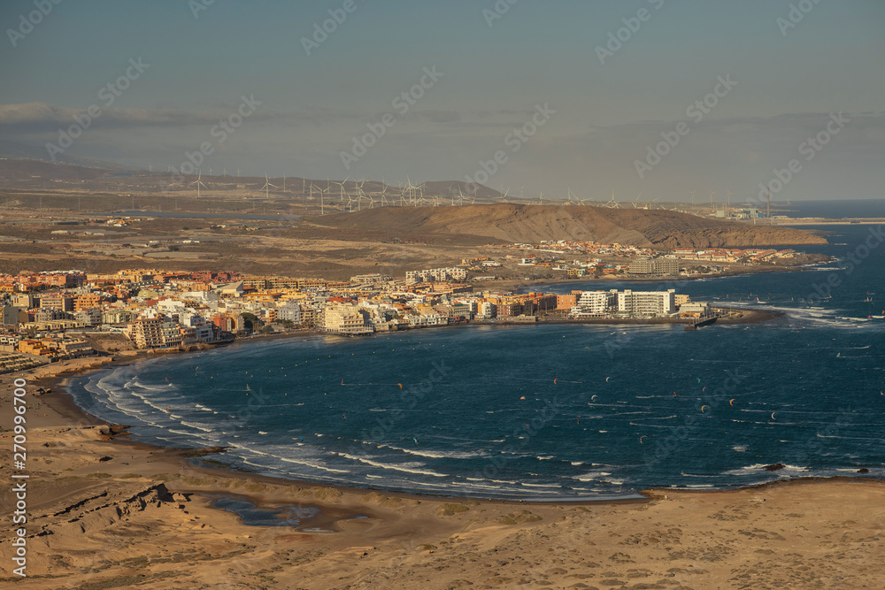 Landscape from the height of the ocean coast, the green line of the coast and small houses, buildings. Tenerife Island.