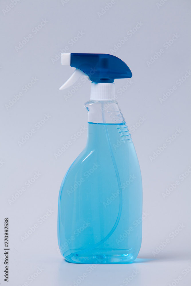 Window cleaner in plastic bottle with spray and fabric towel on gray ( Window cleaner in plastic bottle with spray and fabric towel on gray (
