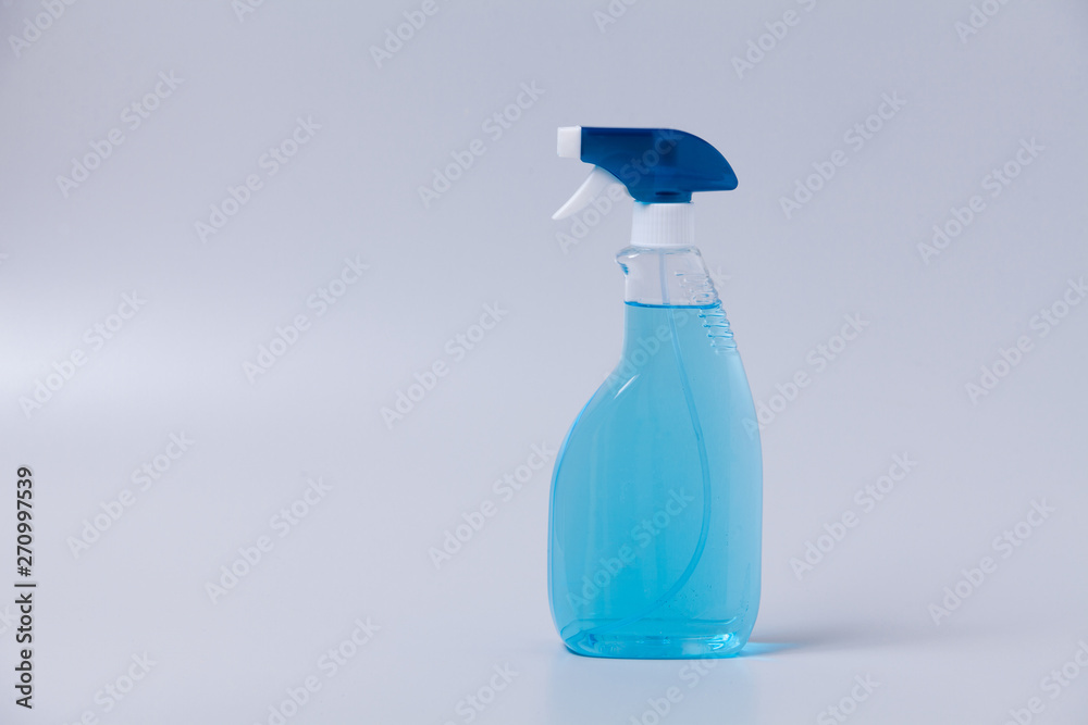 Window cleaner in plastic bottle with spray on gray Window cleaner in plastic bottle with spray on gray