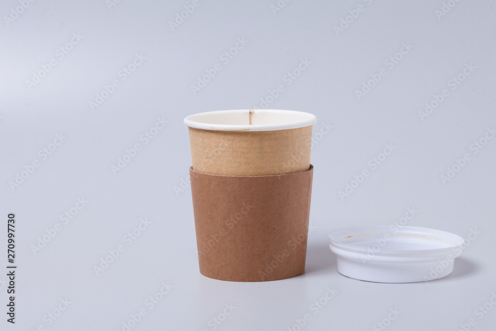 Take away disposable coffee cup on gray background