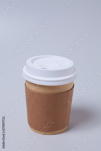 Take away disposable coffee cup on gray background