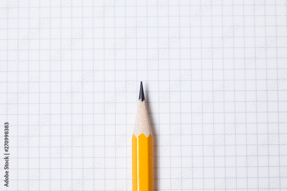 Pencil on blank grid note pad Pencil on blank grid note pad