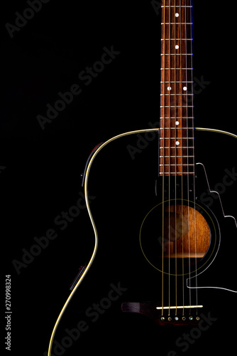 musical instrument wood acoustic six-string guitar isolated on blackbackground