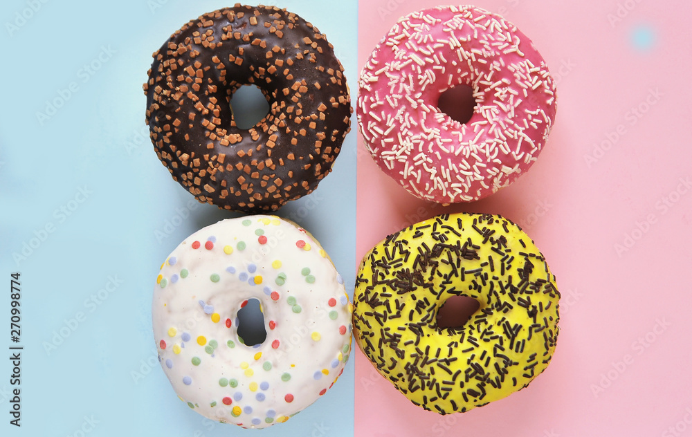 Delicious donuts on light pastel color background. Delicious donuts on light pastel color background.