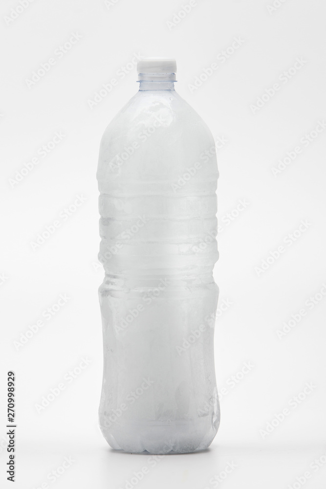 Frozen water in drinking water bottle on white Frozen water in drinking water bottle on white