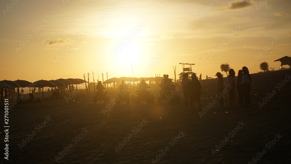 Summer holiday atmosphere enjoying the sunset on the beach