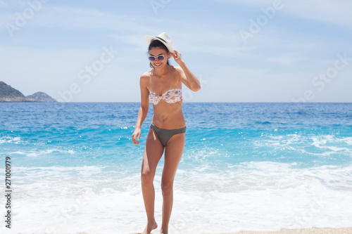 beautiful woman swim wear at the beach in sunny summer © izzetugutmen