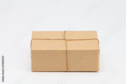 Brown kraft gift wrapped box on white