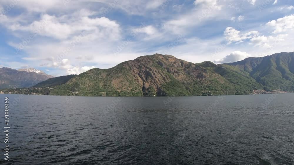 Beautiful scene of lake Como. Big blue lake surrounded by green mountains. Italy, Lombardy, Europe. View of a beautiful medieval city on a shore of blue lake surrounded by green hill Beautiful scene of lake Como. Big blue lake surrounded by green mountains. Italy, Lombardy, Europe. View of a beautiful medieval city on a shore of blue lake surrounded by green hill