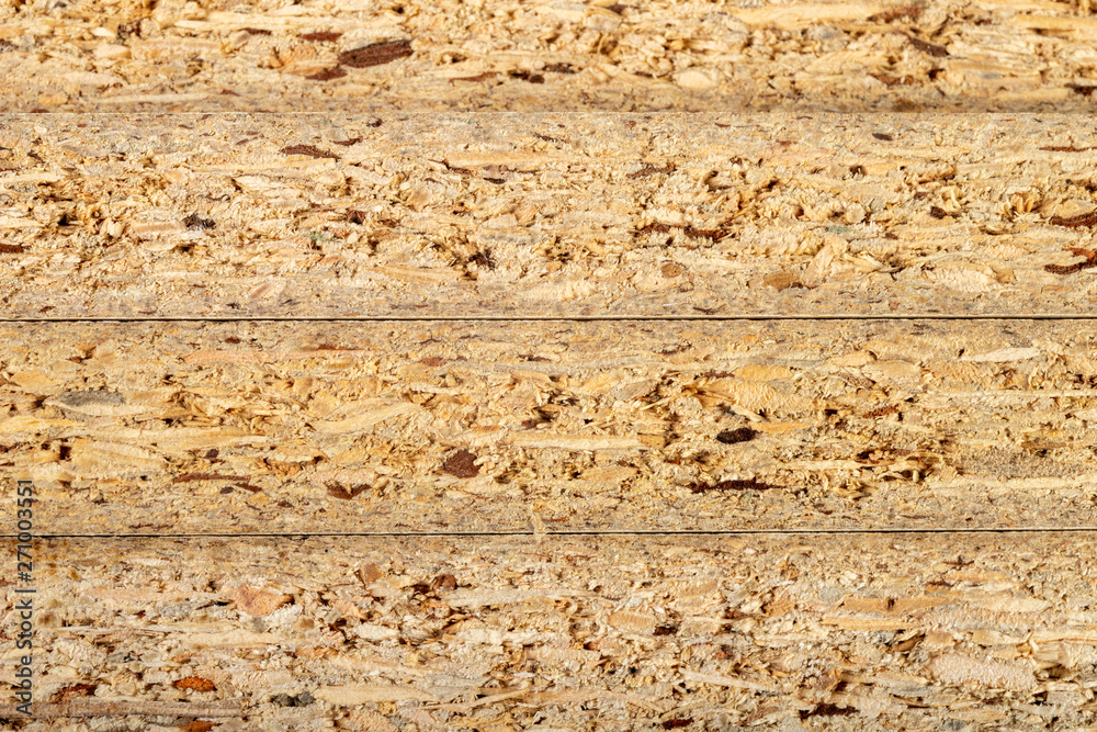 Particleboard with veneer is cut into small pieces. Materials for carpenters to build furniture. Particleboard with veneer is cut into small pieces. Materials for carpenters to build furniture.