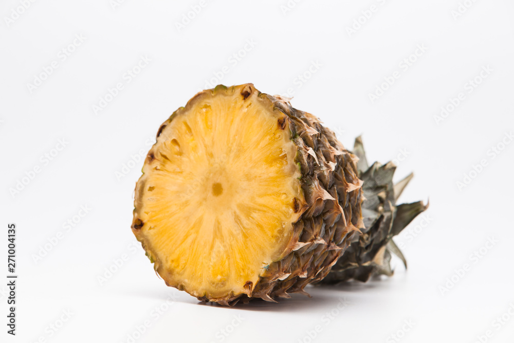 Pineapple cross section on a wooden cutting board Pineapple cross section on a wooden cutting board