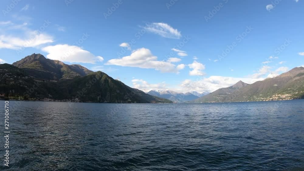 Beautiful scene of lake Como. Big blue lake surrounded by green mountains. Italy, Lombardy, Europe. View of a beautiful medieval city on a shore of blue lake surrounded by green hill Beautiful scene of lake Como. Big blue lake surrounded by green mountains. Italy, Lombardy, Europe. View of a beautiful medieval city on a shore of blue lake surrounded by green hill