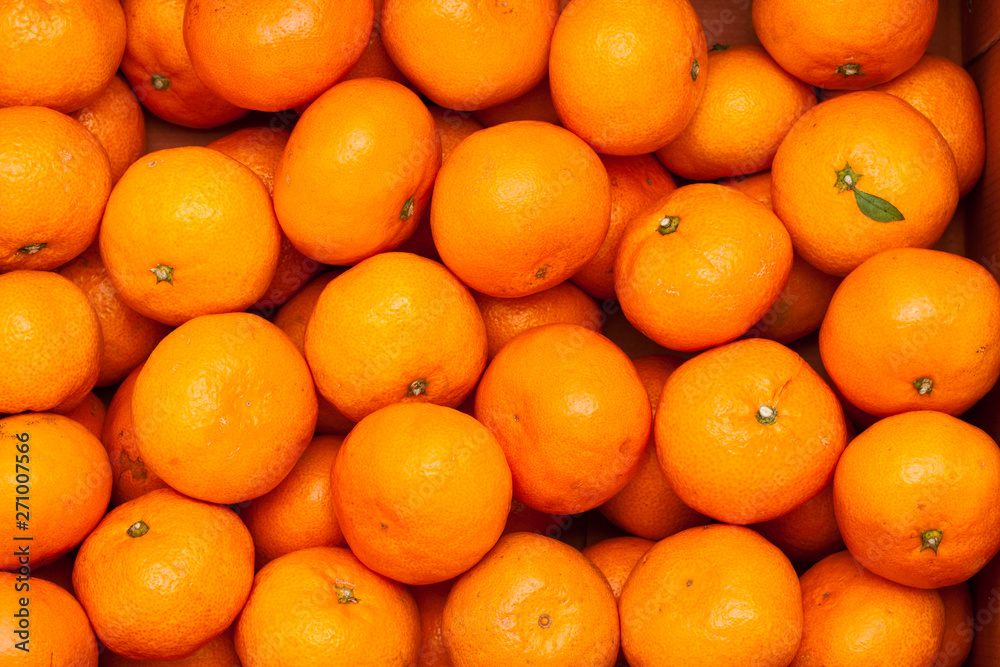 A pile of organic fresh juicy mandarin oranges A pile of organic fresh juicy mandarin oranges