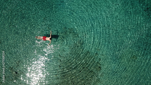 Gocek - Turkey - May 2019 - Aerial View Of Man Swimming In The Crystal Clear Waters of the Dalaman region of Turkey  photo