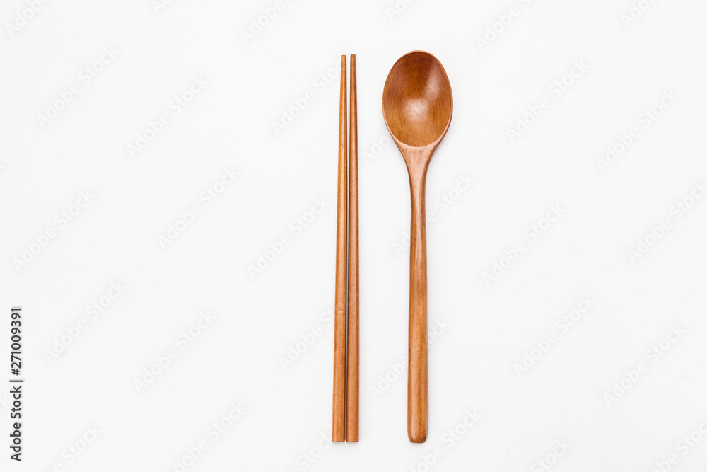 Wooden chopsticks and spoon isolated on white Wooden chopsticks and spoon isolated on white