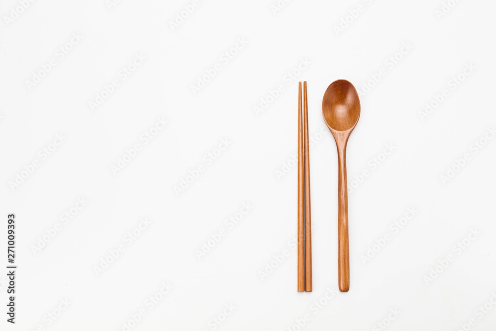 Wooden chopsticks and spoon isolated on white Wooden chopsticks and spoon isolated on white