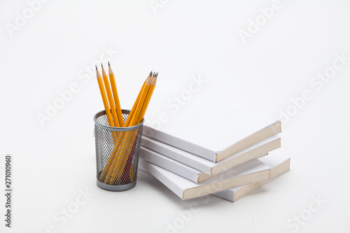 Stack of white book with a pencil case