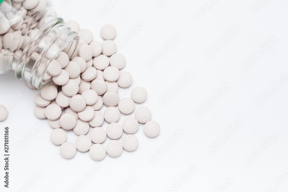 Pills spilling from bottle on isolate 