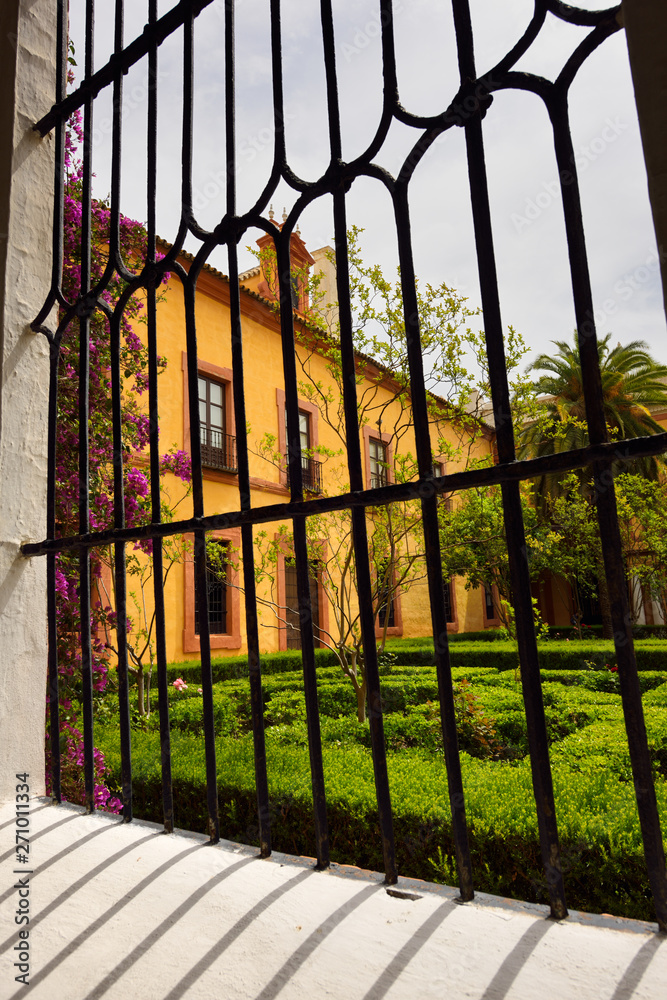 Window to outdoor garden courtyard at the Royal Palace Alcazar of Seville Andalusia Spain Window to outdoor garden courtyard at the Royal Palace Alcazar of Seville Andalusia Spain