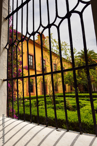 Window to outdoor garden courtyard at the Royal Palace Alcazar of Seville Andalusia Spain