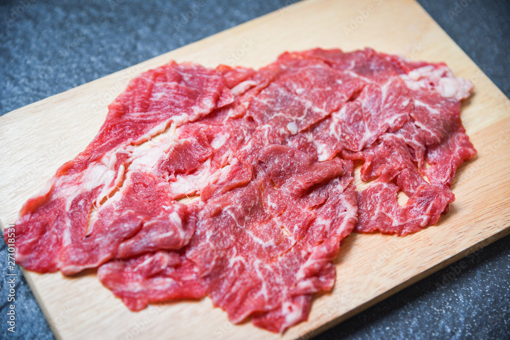 Meat beef slice on wooden cutting board for cooked or Sukiyaki Shabu shabu Japanese foods Asian cuisine - Fresh beef raw Meat beef slice on wooden cutting board for cooked or Sukiyaki Shabu shabu Japanese foods Asian cuisine - Fresh beef raw