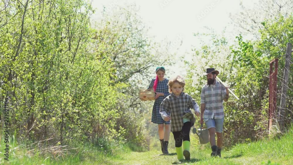 Enjoy in farm. Happy family. Dad mom and son playing together. Eco farm for family. Family farmer concept - spring time. Earth day. Springtime on the ranch. Mother father and son. Enjoy in farm. Happy family. Dad mom and son playing together. Eco farm for family. Family farmer concept - spring time. Earth day. Springtime on the ranch. Mother father and son.