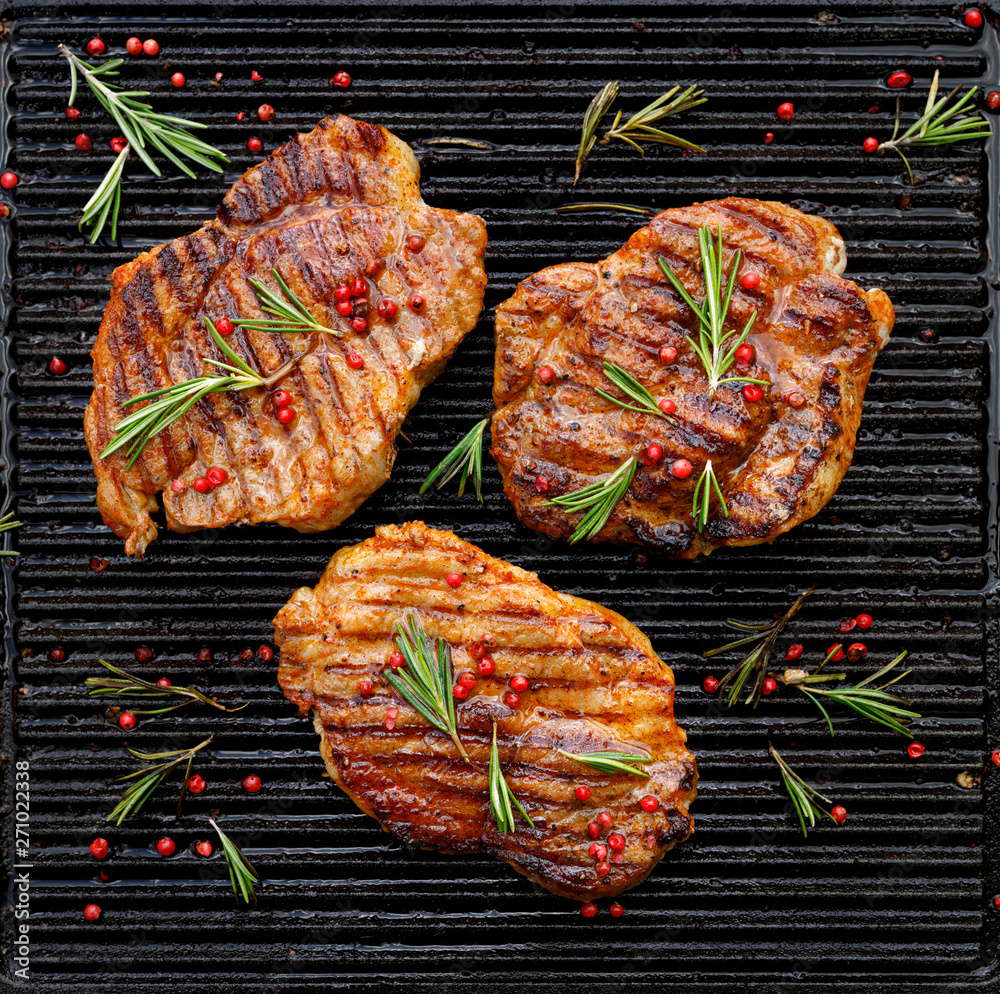 Ταπετσαρία Grilled pork steaks, pork neck with the addition of herbs and spices on the gril