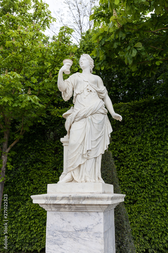 Statue in Park. Woman with Cup