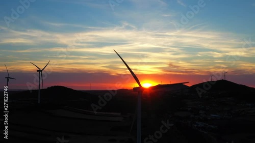 Aerial Wind turbine generators at sunset. Eco renewable energy power production. Loures, Lisboa, Portugal
