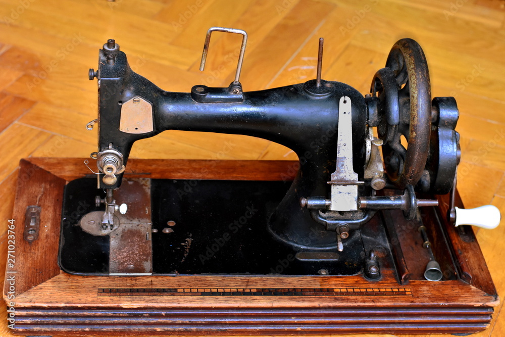 Old dusty retro mechanical sewing machine