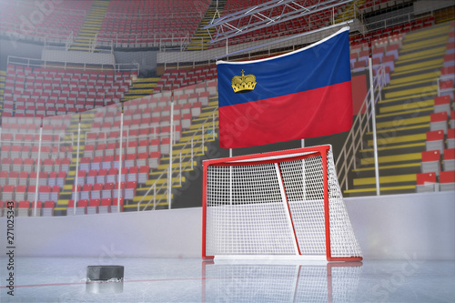 Flag of Liechtenstein in hockey arena with puck and net