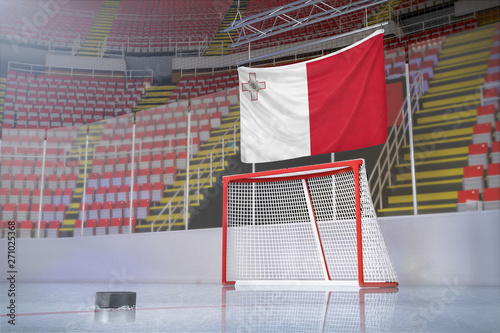 Flag of Malta in hockey arena with puck and net